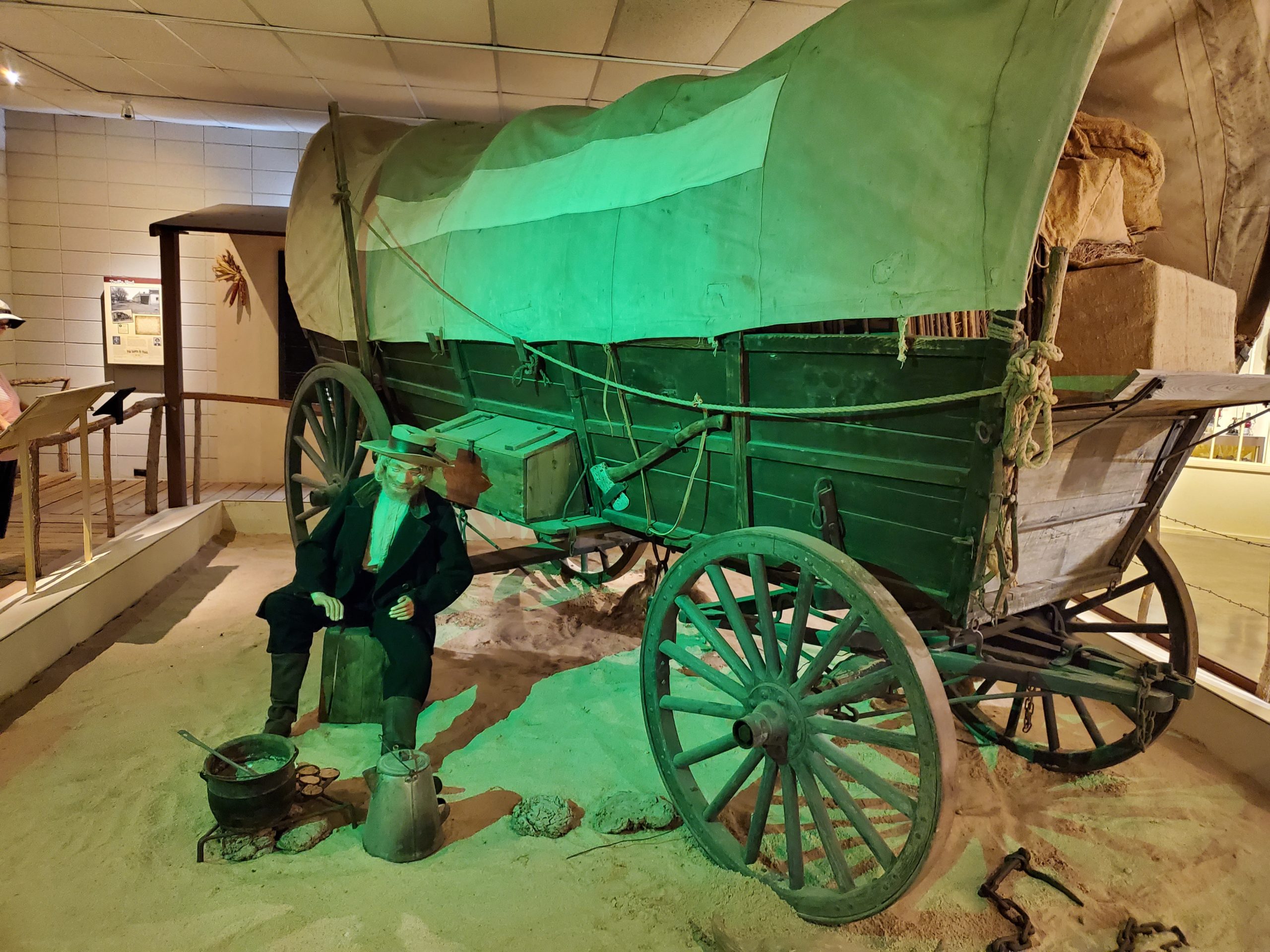 Covered Santa Fe Trail wagon in a museum display.