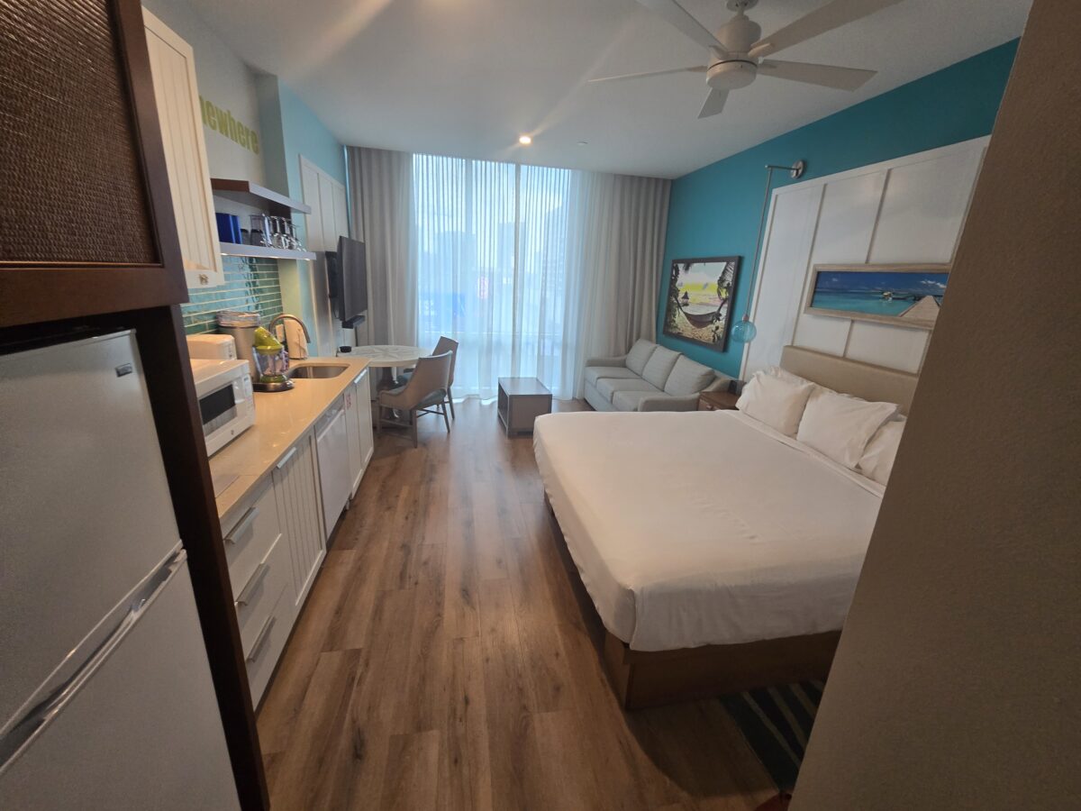 The inside of a studio unit at Margaritaville Atlanta. Shows the bed, sitting are and mini kitchen
