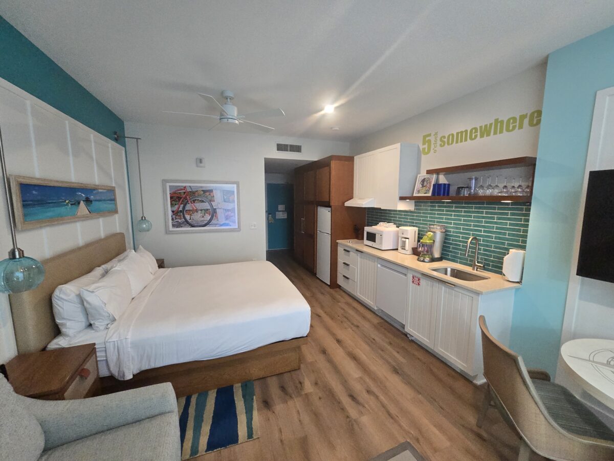 The inside of a studio unit at Margaritaville Atlanta. Shows the bed, sitting are and mini kitchen